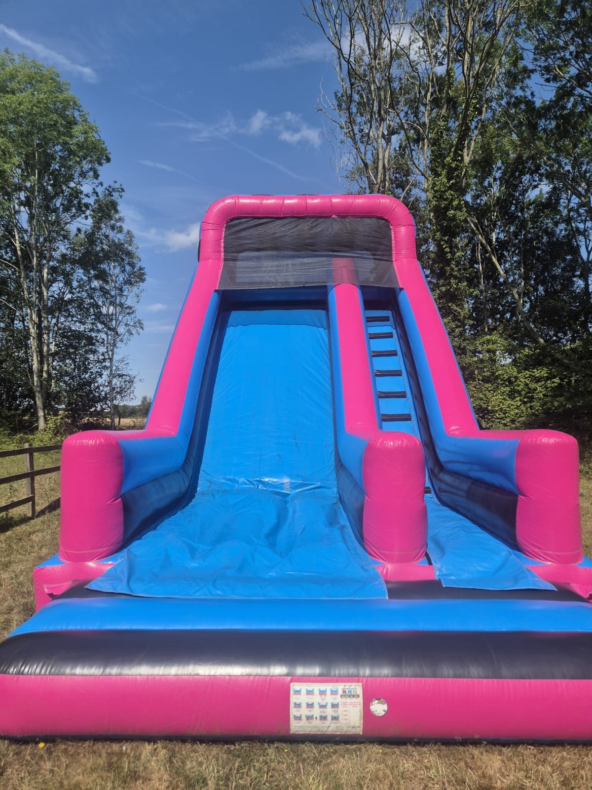Inflatable slide and castles set up at an outdoor fun day