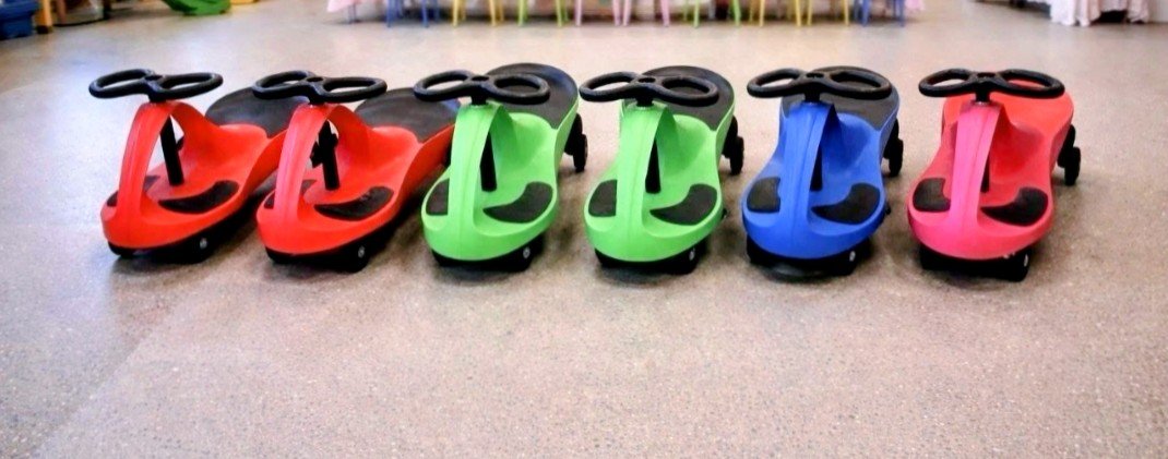 Row of colourful Diddy Cars ride-on toys